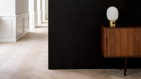 Smoked-oak and stone contrast with bright interiors of Copenhagen home